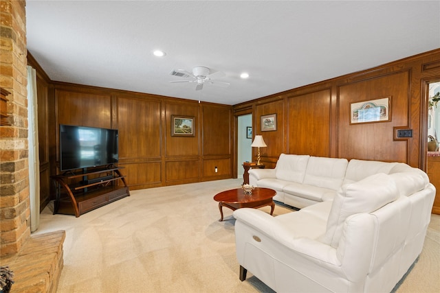 living area featuring ceiling fan, light colored carpet, wood walls, recessed lighting, and visible vents