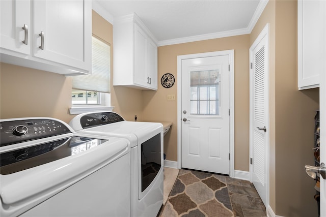 washroom featuring stone finish flooring, washing machine and clothes dryer, cabinet space, baseboards, and ornamental molding