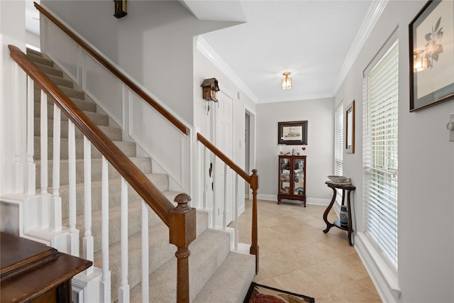 staircase with tile patterned floors and ornamental molding