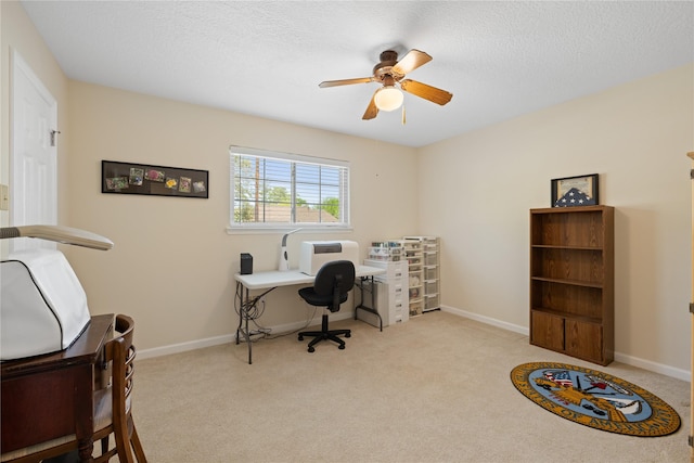 office space with carpet floors, a ceiling fan, baseboards, and a textured ceiling