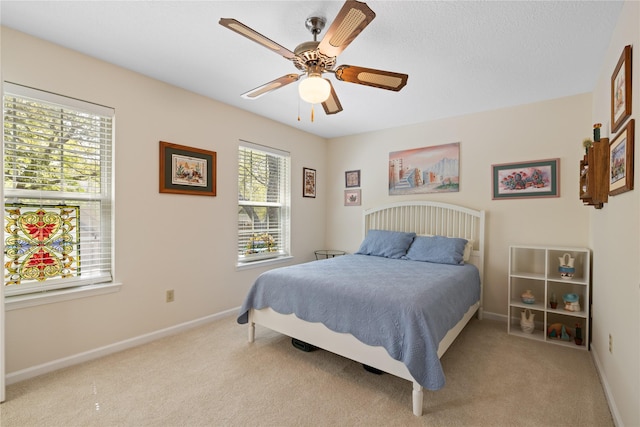 bedroom featuring carpet floors, baseboards, and ceiling fan