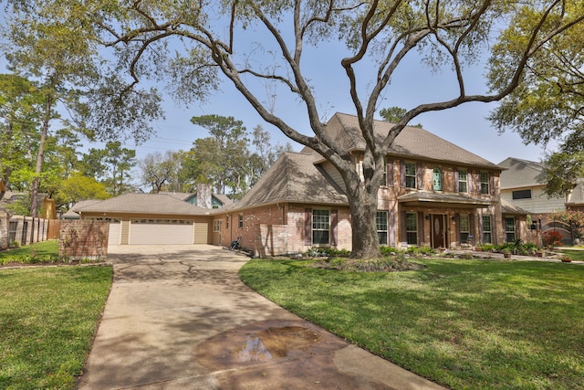view of front of home featuring brick siding, an attached garage, driveway, and a front yard