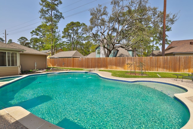 view of pool with a fenced in pool, a fenced backyard, and a sunroom