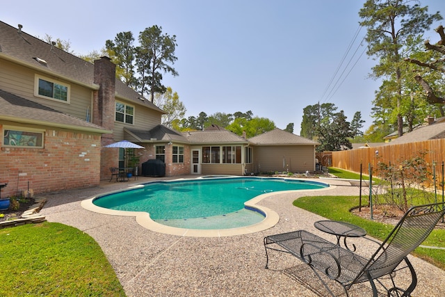 view of swimming pool featuring a patio, fence, and a fenced in pool