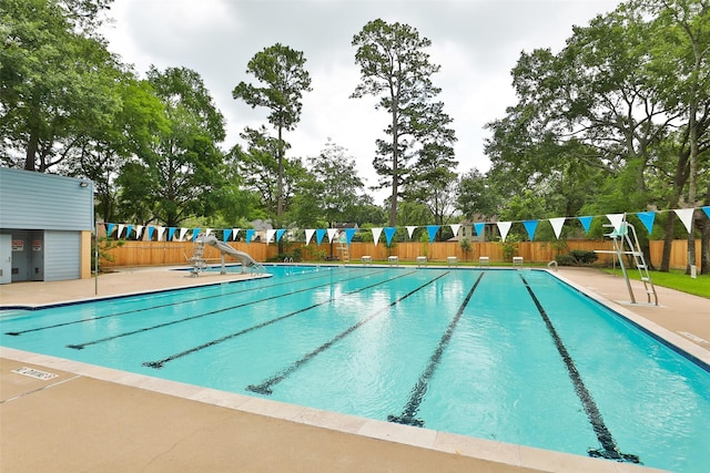 pool featuring fence and a patio area