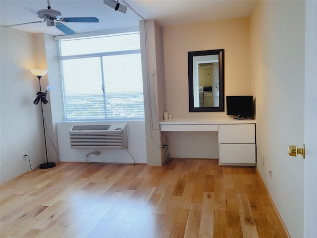 7520 Hornwood Dr Unit 1406, Houston, TX 77036 - interior space with a ceiling fan, built in study area, a wall mounted air conditioner, washer / clothes dryer, and light wood-style floors