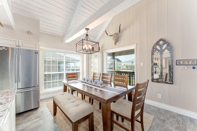 dining area featuring baseboards, light wood-style flooring, vaulted ceiling with beams, wood ceiling, and a chandelier