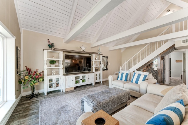 living room with lofted ceiling with beams, stairway, baseboards, and wood finished floors
