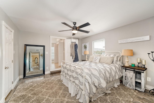 bedroom with wood finished floors, baseboards, a closet, and ceiling fan