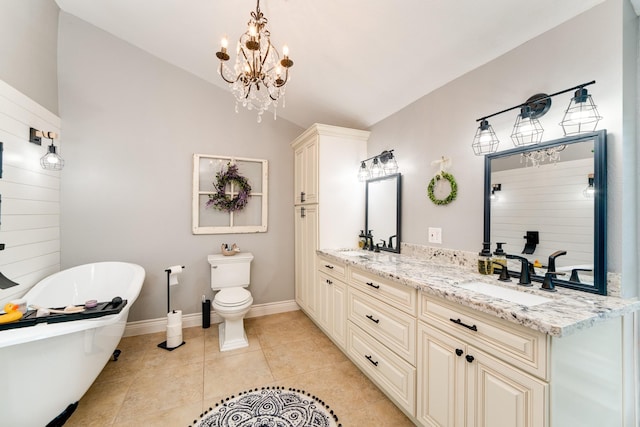 bathroom featuring a sink, a soaking tub, double vanity, and tile patterned flooring