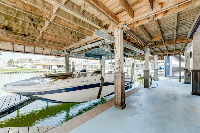 dock area with a water view and boat lift