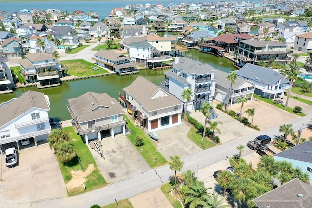 drone / aerial view with a residential view and a water view