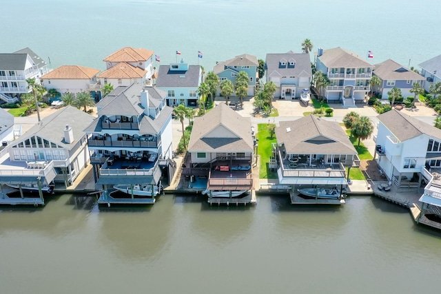 drone / aerial view featuring a residential view and a water view