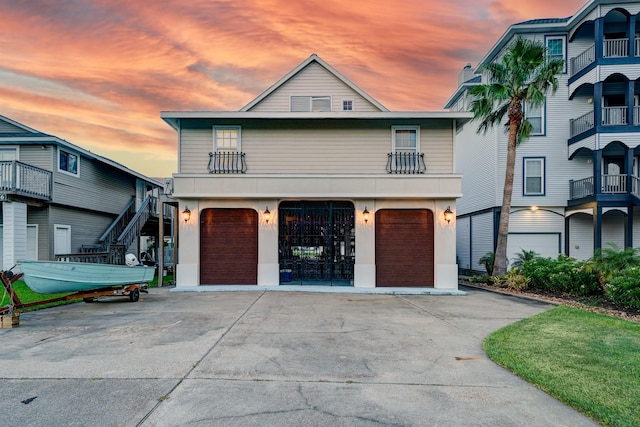 view of front of property featuring concrete driveway, a garage, and stucco siding