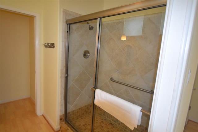 4031 Hardin Dr, Galveston, TX 77554 - bathroom with a shower stall, baseboards, and wood finished floors
