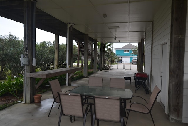4031 Hardin Dr, Galveston, TX 77554 - view of patio / terrace featuring a grill, outdoor dining space, and stairway