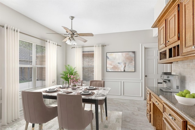 20031 Pine Wind Dr, Humble, TX 77346 - dining room featuring a decorative wall, a ceiling fan, and a wainscoted wall