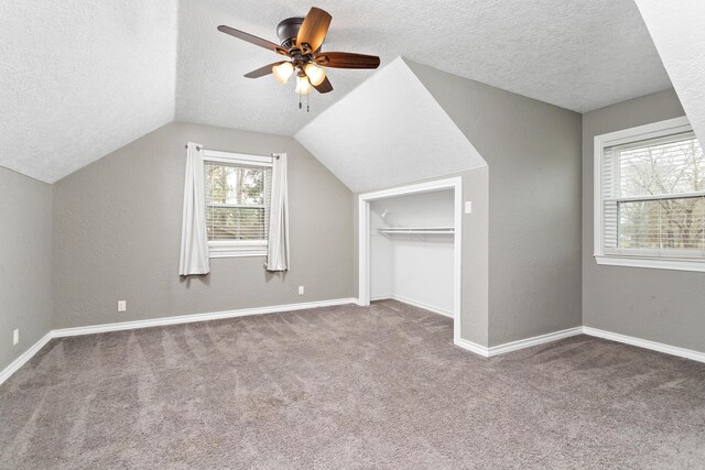 446 Piney Point Dr, Sour Lake, TX 77659 - bonus room with a textured ceiling, carpet floors, baseboards, ceiling fan, and vaulted ceiling