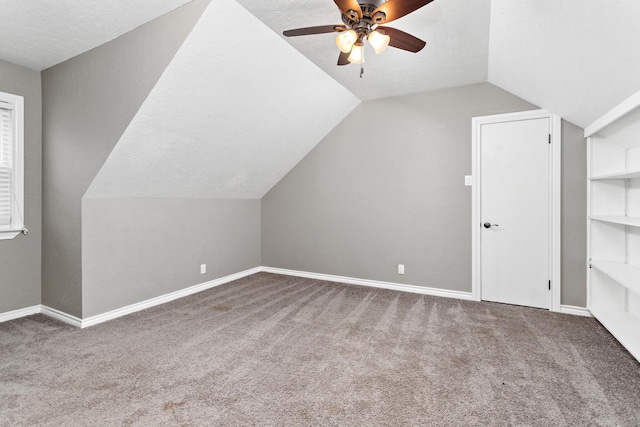 446 Piney Point Dr, Sour Lake, TX 77659 - additional living space featuring baseboards, carpet floors, lofted ceiling, ceiling fan, and a textured ceiling