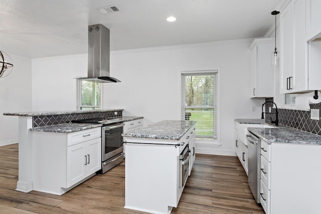 446 Piney Point Dr, Sour Lake, TX 77659 - kitchen with a sink, a kitchen island, appliances with stainless steel finishes, island range hood, and light stone countertops