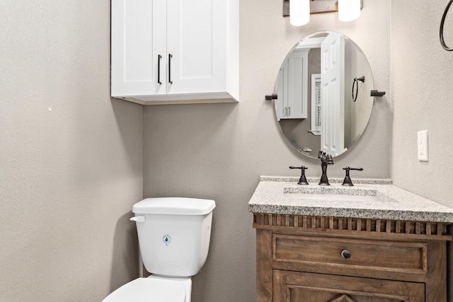 446 Piney Point Dr, Sour Lake, TX 77659 - half bath featuring toilet, vanity, and a textured wall