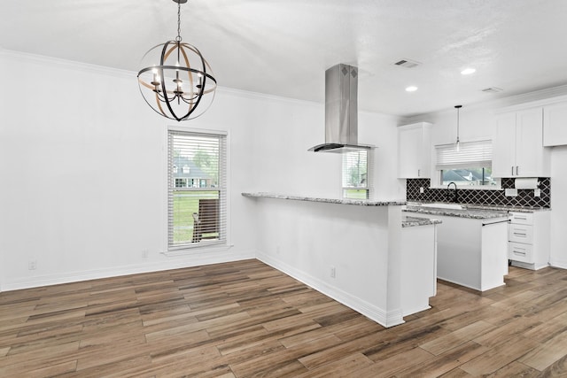 446 Piney Point Dr, Sour Lake, TX 77659 - kitchen with tasteful backsplash, visible vents, island exhaust hood, and crown molding