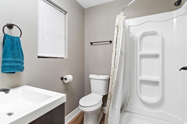 446 Piney Point Dr, Sour Lake, TX 77659 - full bathroom featuring vanity, toilet, a shower with shower curtain, and baseboards