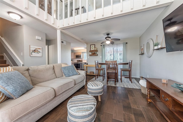 908 Calico Jack Cv, Galveston, TX 77554 - living area with dark wood-type flooring, ceiling fan, and stairs