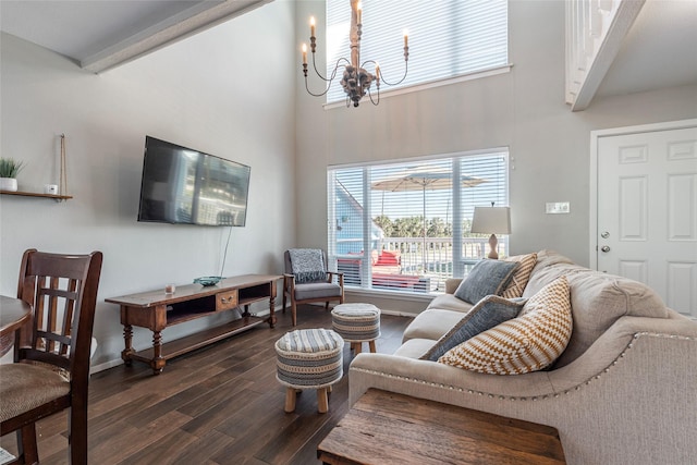 908 Calico Jack Cv, Galveston, TX 77554 - living area with a towering ceiling, dark wood finished floors, a chandelier, and baseboards