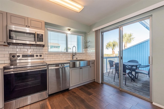 908 Calico Jack Cv, Galveston, TX 77554 - kitchen featuring appliances with stainless steel finishes, a sink, healthy amount of natural light, and tasteful backsplash