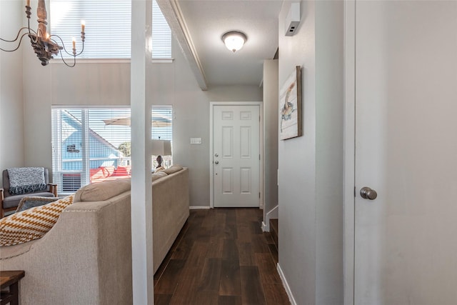 908 Calico Jack Cv, Galveston, TX 77554 - corridor featuring dark wood-type flooring, a chandelier, and baseboards