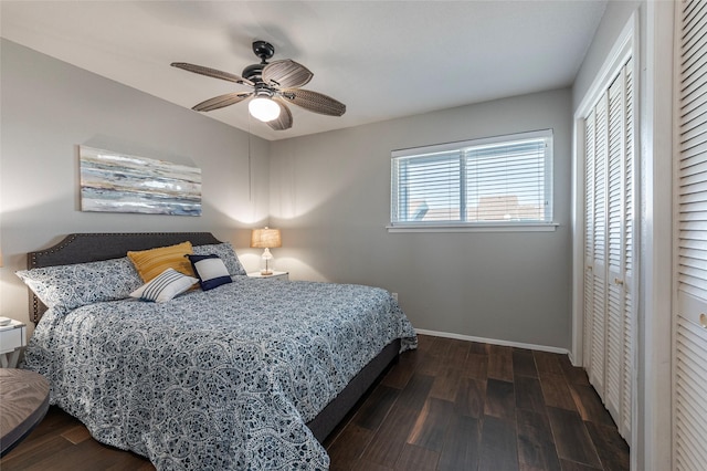 908 Calico Jack Cv, Galveston, TX 77554 - bedroom with wood finished floors, baseboards, two closets, and a ceiling fan