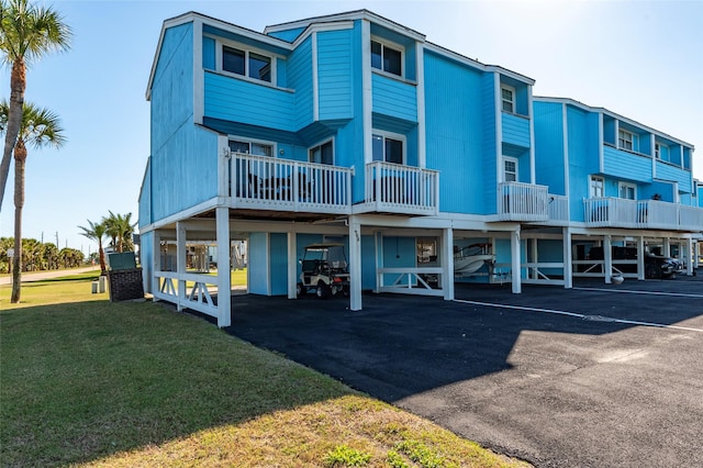 908 Calico Jack Cv, Galveston, TX 77554 - rear view of house with a lawn and parking