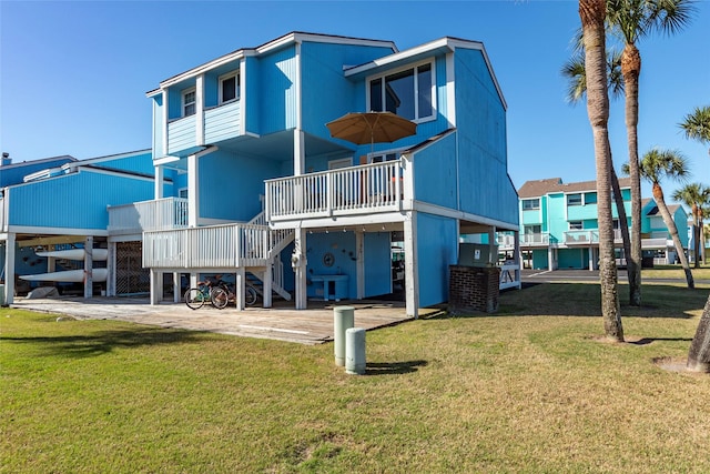 908 Calico Jack Cv, Galveston, TX 77554 - rear view of property featuring stairs, a lawn, a wooden deck, and a carport
