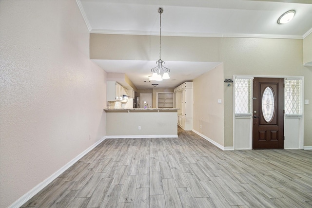 12007 Fairpoint Dr, Houston, TX 77099 - foyer entrance featuring baseboards, a notable chandelier, light wood-style flooring, and ornamental molding