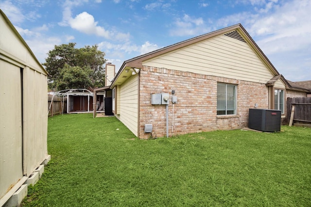 12007 Fairpoint Dr, Houston, TX 77099 - view of home's exterior with cooling unit, a fenced backyard, and a yard