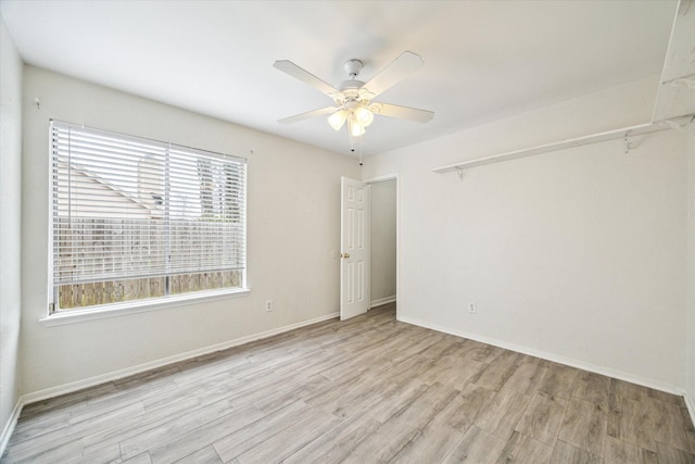 12007 Fairpoint Dr, Houston, TX 77099 - empty room featuring light wood-style flooring, baseboards, and a ceiling fan