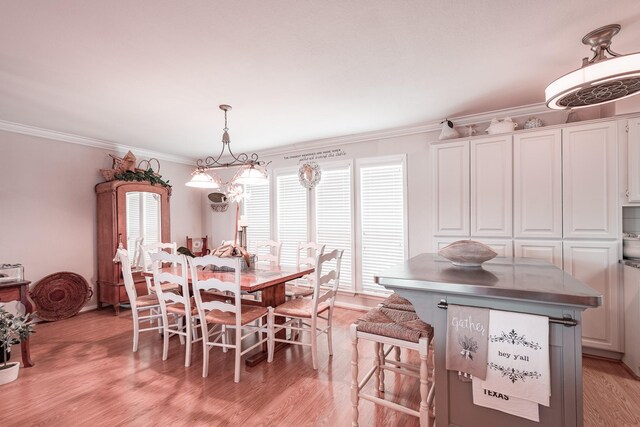 1818 Tiki Dr, Galveston, TX 77554 - dining area with light wood finished floors and crown molding