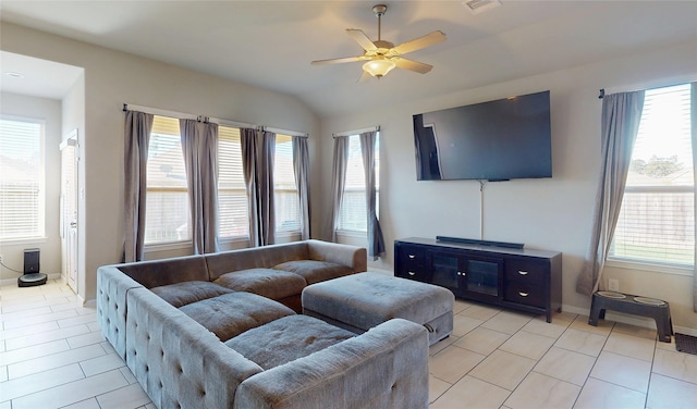 living room with a ceiling fan, baseboards, and a healthy amount of sunlight