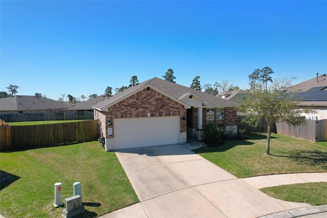 ranch-style home with brick siding, an attached garage, fence, and a front yard