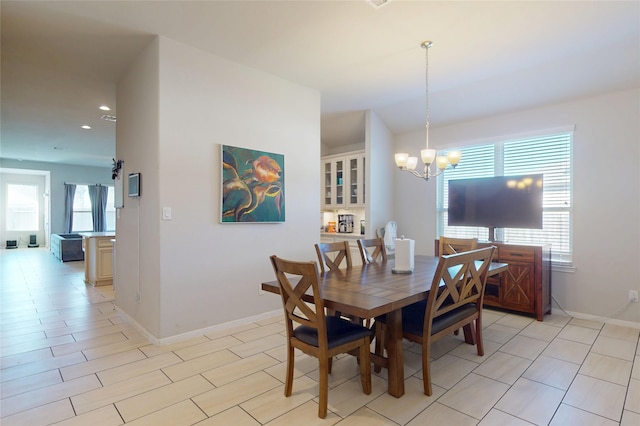 dining area with baseboards, recessed lighting, and a notable chandelier