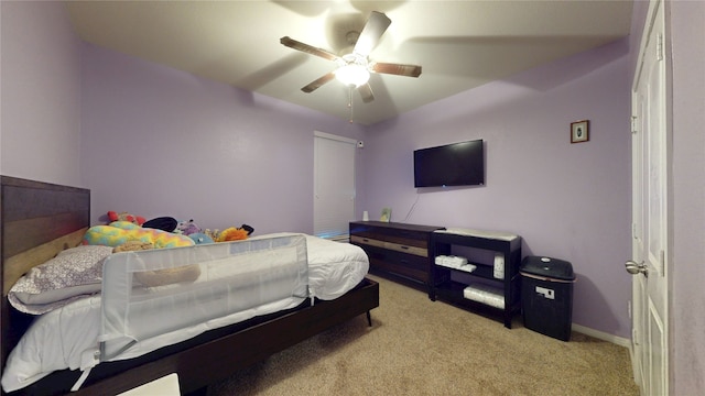 carpeted bedroom with baseboards and ceiling fan