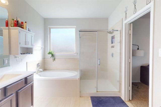 full bath with a garden tub, a stall shower, and vanity