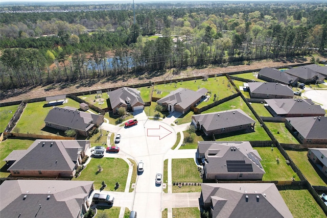 birds eye view of property with a wooded view and a residential view