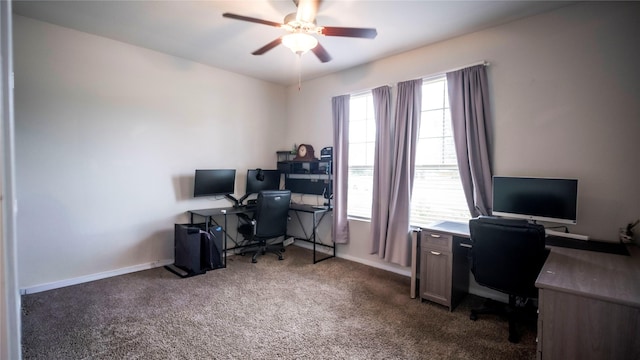 office featuring baseboards, a ceiling fan, and dark colored carpet