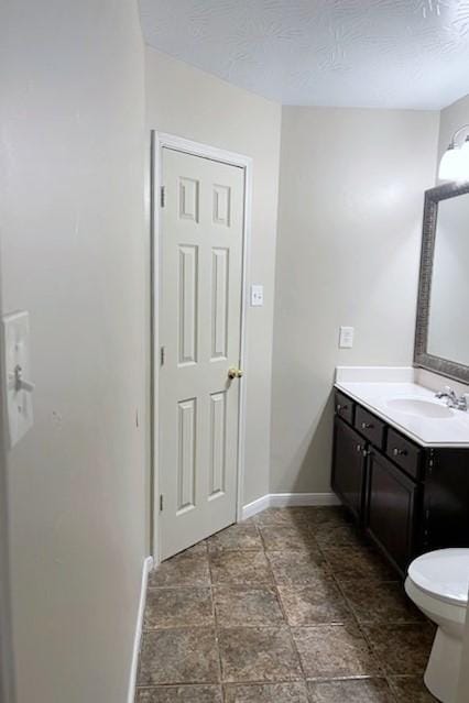 7931 Clarion Way, Houston, TX 77040 - bathroom with vanity, baseboards, toilet, and stone finish flooring