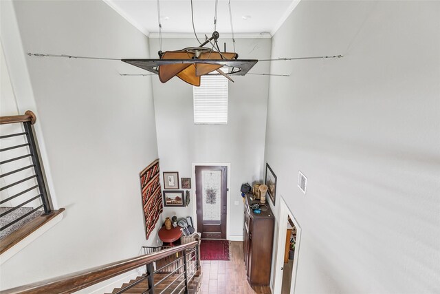 719 Tarpaulin Way, Crosby, TX 77532 - entryway with crown molding, a high ceiling, wood finished floors, and visible vents