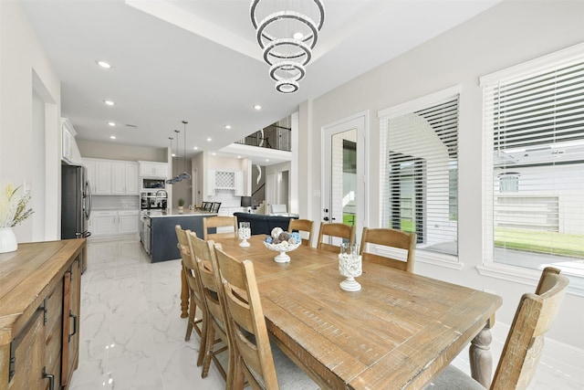 dining area featuring a notable chandelier, marble finish floor, recessed lighting, stairway, and baseboards