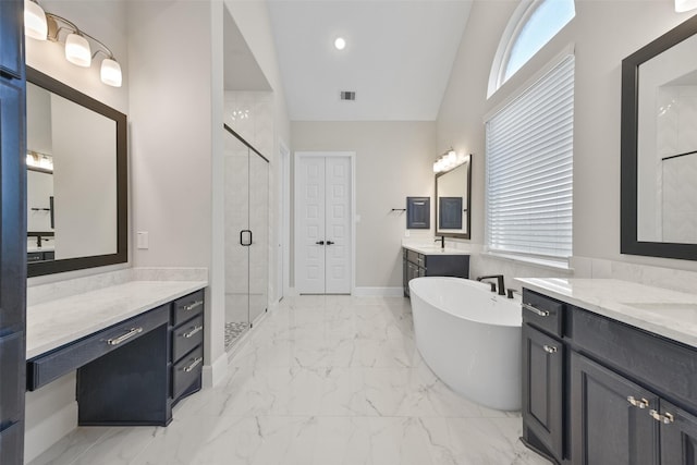 bathroom featuring visible vents, a freestanding tub, a sink, a shower stall, and marble finish floor
