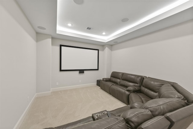 carpeted home theater featuring visible vents, recessed lighting, a tray ceiling, and baseboards